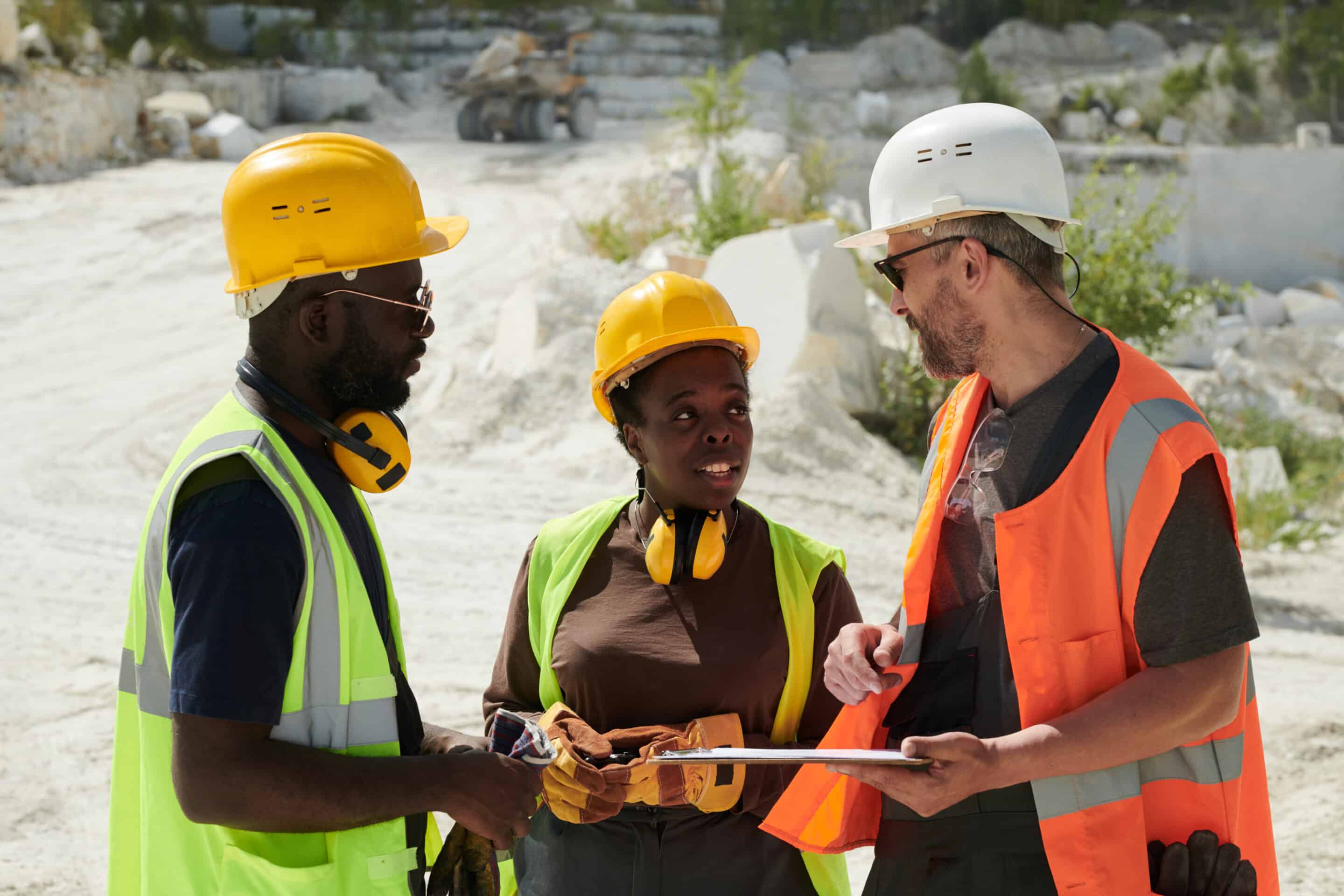 Two African American workers of marble quarry talking to their foreman